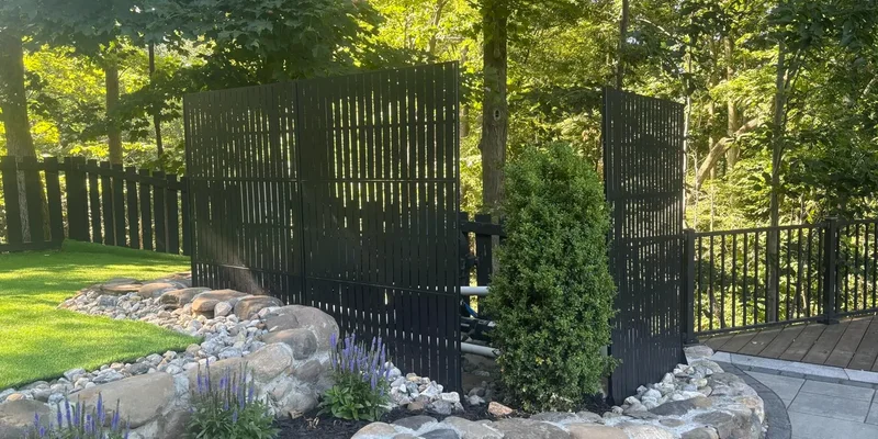 Metal privacy screen panels in a landscaped garden